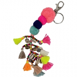 Keychain and bag accessory with multicolored fluo pom poms, tassels and charms with shells