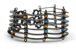 Antique silver bracelet with metallic rays and wooden beads